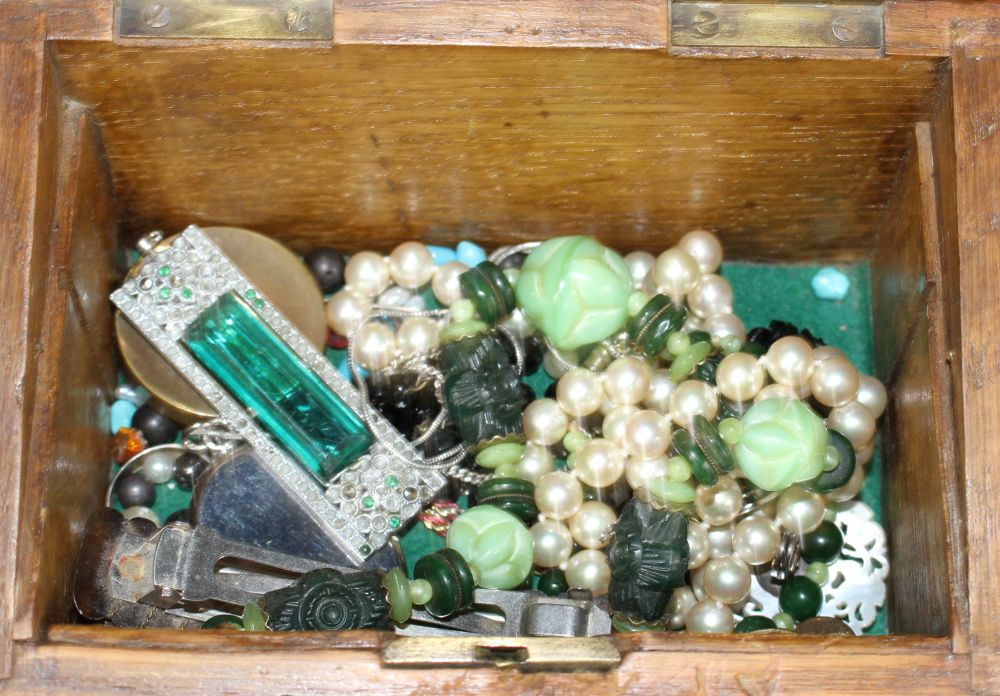 A wooden box containing assorted jewellery etc.